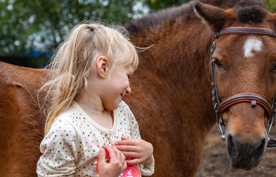 Close-up of girl with horse