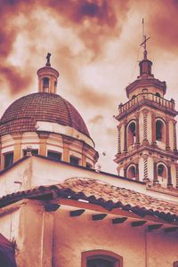 Low angle view of building against cloudy sky
