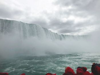 Scenic view of waterfall against sky