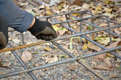 High angle view of person hand on metal