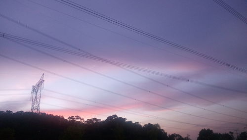 Low angle view of electricity pylon against sky