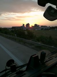 Close-up of car against sky during sunset