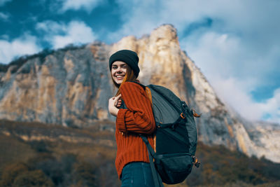 Man standing on rock against mountain