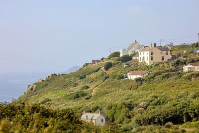 Houses on hill against clear sky