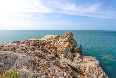 Rock formations by sea against sky