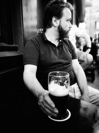 Midsection of man holding ice cream in restaurant