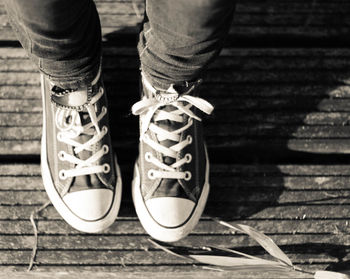 Low section of man wearing canvas shoes