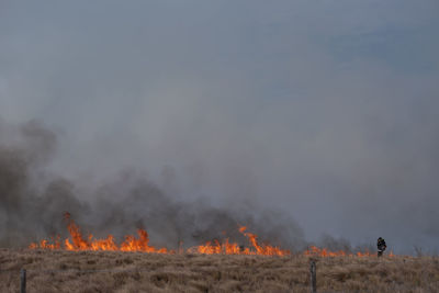 Bonfire on field against sky