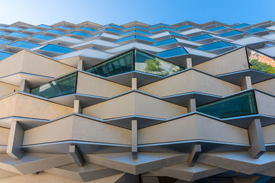 Low angle view of modern building against clear blue sky