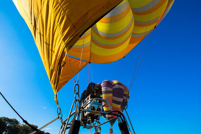 Low angle view of hot air balloon against blue sky