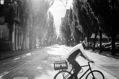 Man cycling on street in city