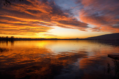 Scenic view of lake against romantic sky at sunset