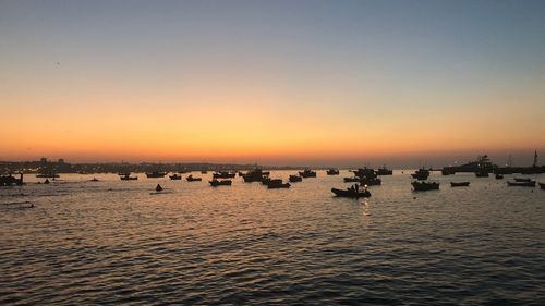 Scenic view of sea against clear sky during sunset