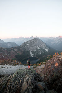 Man looking at mountain against sky