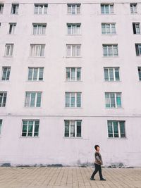 Full length of woman standing on window