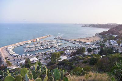 High angle view of sea and buildings against sky