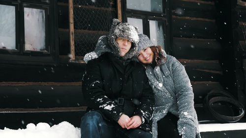 Winter portrait. happy, funny couple in love, man and woman, dressed in warm winter clothes