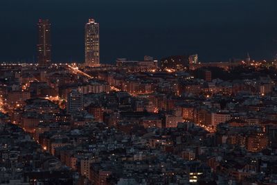 Aerial view of city lit up at night