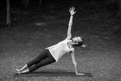 Young woman stretching at park