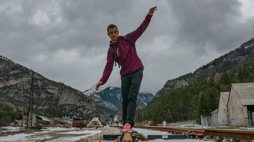 Full length of man standing on mountain against sky