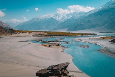 Scenic view of lake and mountains against sky