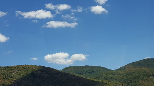 Scenic view of mountains against blue sky