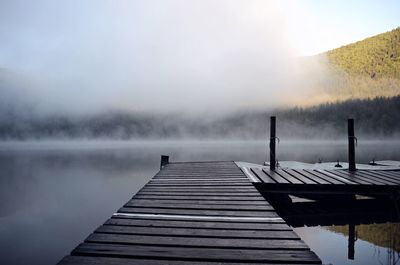 Pier over lake against sky