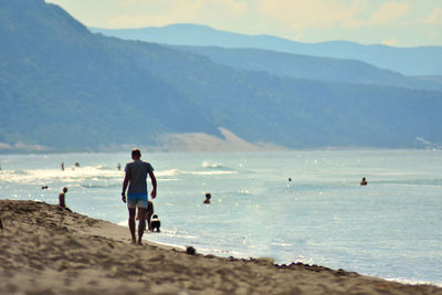People on beach against sky