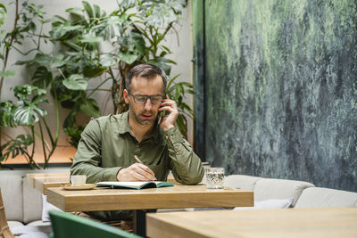 Portrait of man sitting on table