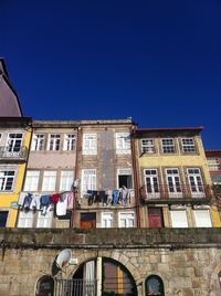 Low angle view of buildings against clear blue sky