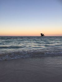 Scenic view of sea against clear sky during sunset