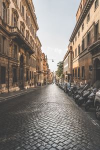 Street amidst buildings in city against sky