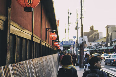 People walking on footpath in city