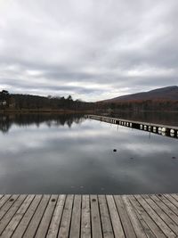 Pier over lake against sky