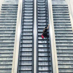 Rear view of woman walking on staircase