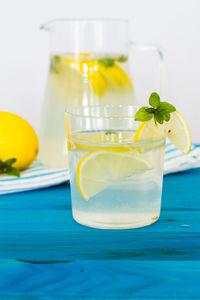 A glass of juice with lemonade on table