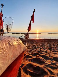 Fishingboat at the beach, clear sky and sunset