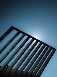 Low angle view of metallic structure against clear blue sky