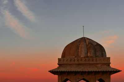 Low angle view of bell tower against sky during sunset