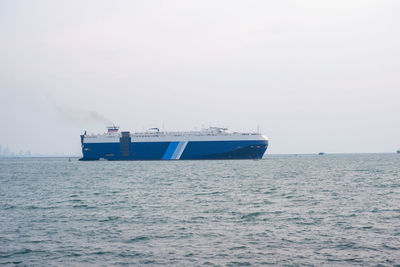 Ship sailing on sea against clear sky