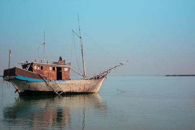 Boat in sea against clear sky