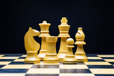 Close-up of chess pieces against black background