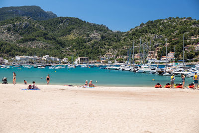 People on beach against sky