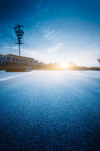 View of road against blue sky during sunset