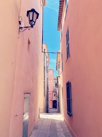 Low angle view of alley amidst buildings