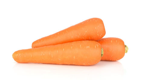 Close-up of orange slices over white background