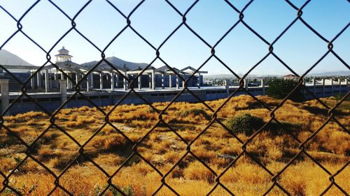 Close-up of chainlink fence against sky