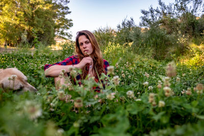 Portrait of woman sitting on field