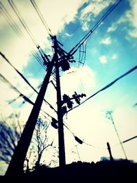 Low angle view of electricity pylon against sky