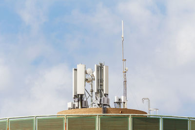 Low angle view of communications tower against sky